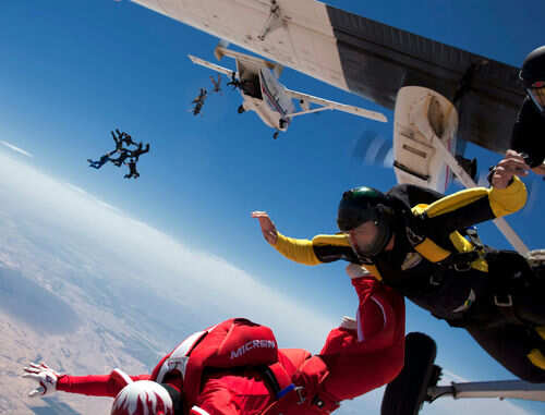 Skydivers jumping from an airplane in midair