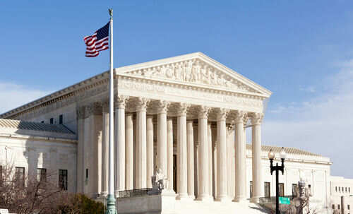 supreme-court_96721225 United States Supreme Court building with American flag