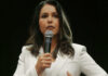 Washington’s Biolab Web—Where’s The Oversight? Woman in white suit speaking into a microphone