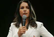 Washington’s Biolab Web—Where’s The Oversight? Woman in white suit speaking into a microphone