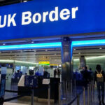 UK border entry with barriers and signs