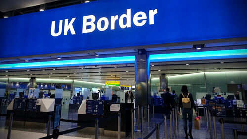 UK border entry with barriers and signs