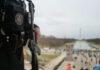 Officer holds rifle overlooking National Mall event