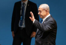The Trump-Netanyahu Rift Draws New Attention I dont know who this person is waving