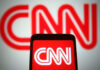 CNN Panel Implodes Over Explosive ICE Remarks CNN logo displayed on phone and screen.