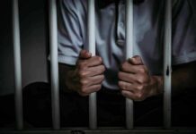 Minnesota Meltdown: Walz Backs Explosive Pardon person gripping prison bars