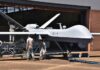 The Air Force’s New Wingmen Take Flight Military drone being serviced by ground crew outside a hangar