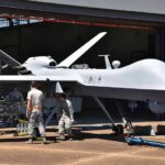 The Air Force’s New Wingmen Take Flight Military drone being serviced by ground crew outside a hangar