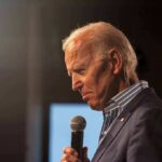 The Biden Recordings May Finally Surface elderly man holding a microphone on stage