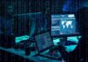 cybersecurity analysts at workstations with code and world map on screens