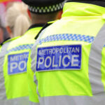 Predator Stopped — Accountability Missing Two police officers in high-visibility jackets at a public event