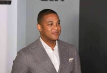 Another Nazi Comparison, Another Political Firestorm man in gray suit smiling at event