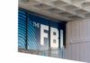 FBI sign on building facade behind metal fence