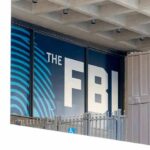 The Arrest That Never Happened Still Haunts FBI sign on building facade behind metal fence