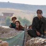 Climate Or Culture? ABC Sparks Fresh Debat Group of people sitting by a low earthen wall