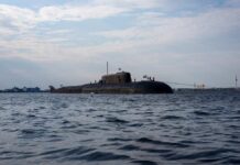 A submarine in the ocean with people on its surface