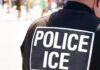 Close-up of a police officer's back with a 'POLICE ICE' badge