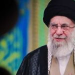 Iran’s Biggest Display Raises New Questions A religious leader speaking in traditional attire against a colorful background