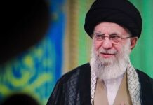Iran’s Biggest Display Raises New Questions A religious leader speaking in traditional attire against a colorful background