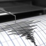 Seismograph needle recording earthquake waves on paper
