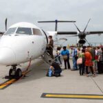 Passengers boarding a small aircraft at an airport