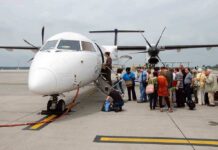 Passengers boarding a small aircraft at an airport