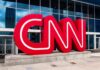 CNN red logo sculpture outside a modern glass building