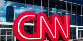 CNN red logo sculpture outside a modern glass building