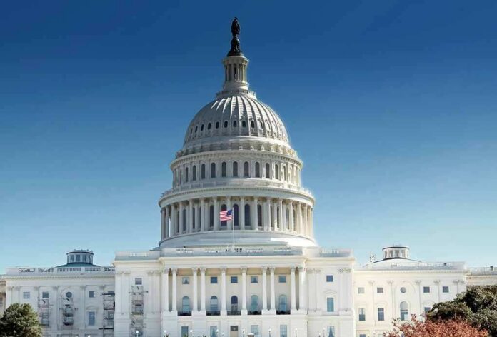 United States Capitol building with dome under clear blue sky