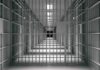 empty prison corridor with barred cells