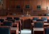 Empty courtroom with wooden benches and judge's bench