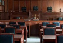 Empty courtroom with wooden benches and judge's bench