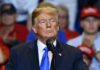 No Iran Help? Trump Rethinks The War Games man in suit speaking at a rally podium