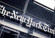 The New York Times sign on a glass building facade