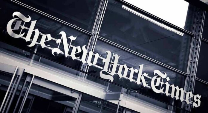 The New York Times sign on a glass building facade