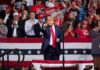 Trump Floods Myrtle Beach—But Does It Move Votes? man in suit points from a stage at a political rally