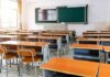 Empty classroom with rows of desks and a chalkboard
