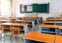 Empty classroom with rows of desks and a chalkboard