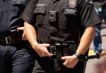 Police officers in black uniforms with duty belts
