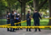 Daylight Violence Shocks an Upper East Side Co-Op crime scene tape with police officers in a park