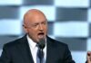 Kelly Questions Trump’s Iran Exit Strategy Bald man in suit speaking into a microphone