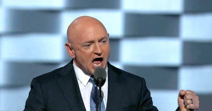 Bald man in suit speaking into a microphone