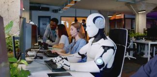 Robot and office workers at computers in a modern workspace