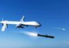 military drone firing missiles in clear blue sky