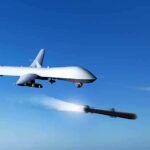 military drone firing missiles in clear blue sky