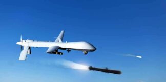 military drone firing missiles in clear blue sky