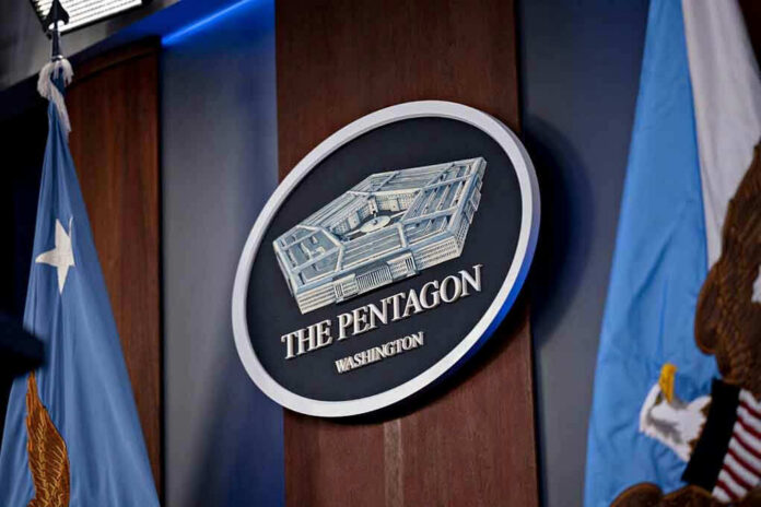 2265798341 The Pentagon emblem between two flags.