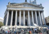 Donor Dollars, Rare Favor—What Changed? Reporters and photographers gathered outside a neoclassical courthouse