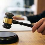 Campus Assault Case: Suspension Stands, For Now Judge's hand holding a gavel over a sound block