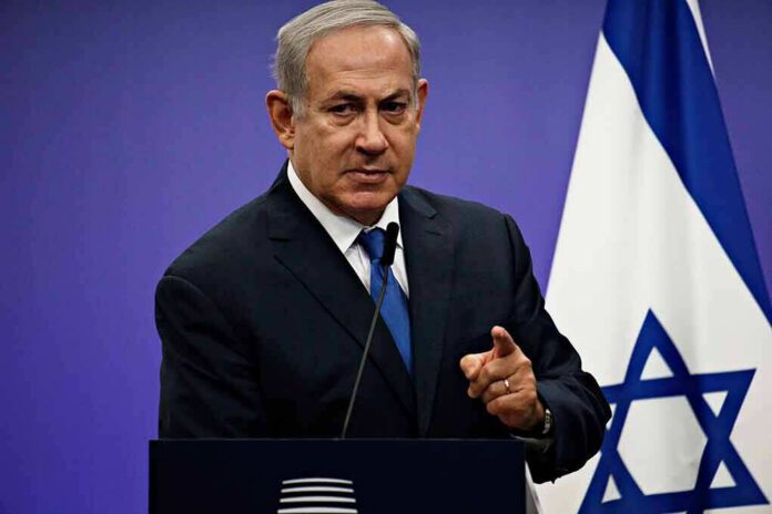 shutterstock_1042782061 man in suit speaking at podium with Israeli flag